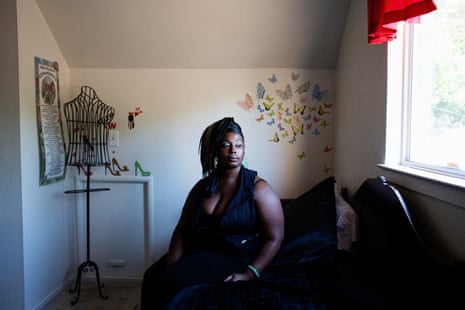 Willia, 37, sits on a bed at a Sex Workers Outreach Project house in Sacramento, California, in September.