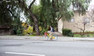 A Google employee bikes in front of the Martinellis’ property at 1851 Charleston Road, in the middle of the Google campus.