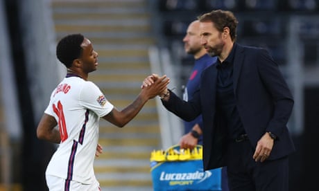 Raheem Sterling shakes hands with Gareth Southgate after being substituted.