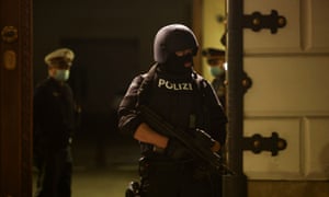 A police officer stands on guard in front of the Ministry of the Interior as a press conference follows talks about gunshots in Vienna.