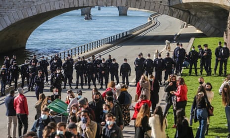 Police disperse gatherings on the banks of the Seine in Paris on Saturday.