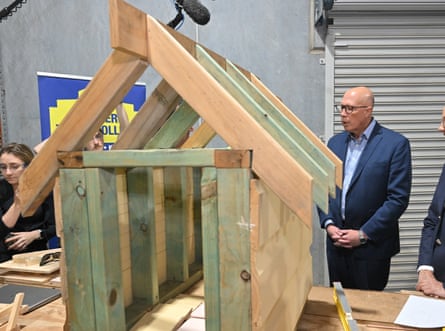 Peter Dutton inspects a dog house at the Hunter Trade College