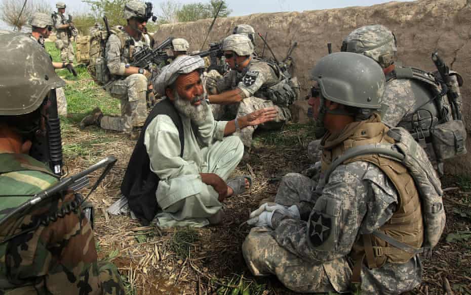 US and Afghan soldiers question a farmer after a firefight with the Taliban in Kandahar province, Afghanistan, in 2010.