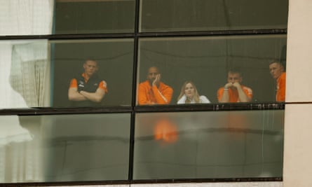 Scott McTominay, Luke Shaw and Lee Grant watch the protest from the window of the Lowry hotel