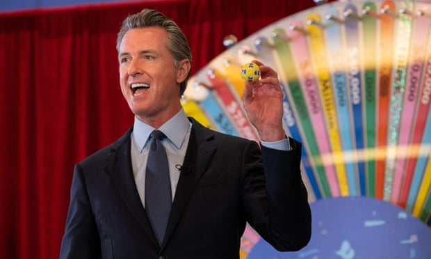 California governor Gavin Newsom holds a lottery ball selected for the first of 15 Californians to be awarded $50,000 for doing their part in getting vaccinated against Covid-19.