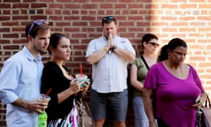 People gather and pray at an informal memorial where Heather Heyer was killed