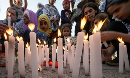 People in Beirut light candles in memory of those killed in the airstrike