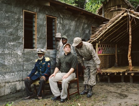 Chief Isaac, documentary-maker Cevin Soling and villagers in military fatigues celebrate John Frum Day in Tanna, 2014