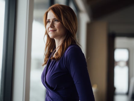 a woman looking out a window.