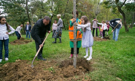 Families plant ‘birthday trees’ for children.