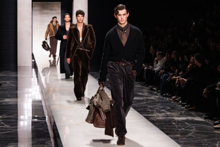 Four white male models walking down the runway