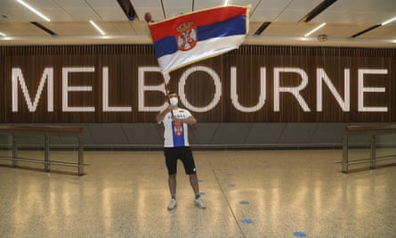 A fan shows his support for Serbia’s Novak Djokovic in the arrivals hall at Melbourne Airport.