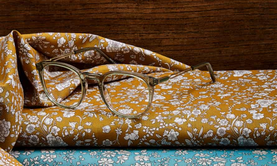 Eyeglasses on top of floral printed fabric