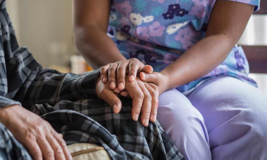 Carer holding patient’s hand