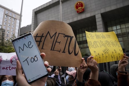 Supporters hold banners as they wait for of Zhou Xiaoxuan outside at a courthouse Dec. 2, 2020.