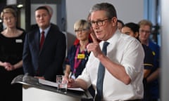 Keir Starmer speaks as medical staff and Health Secretary Wes Street look on.