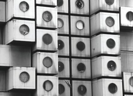 Exterior view of the asymmetric concrete cubes that make up the Nakagin Capsule Tower in Tokyo, Japan