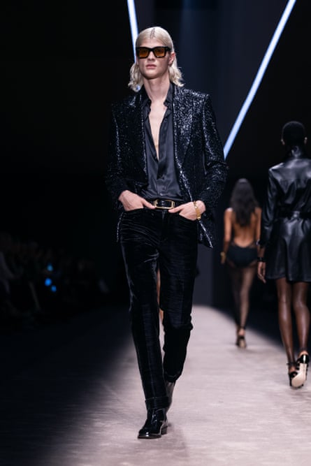 Male model wearing Tom Ford velvet trousers, a silk shirt and sequinned jacket.