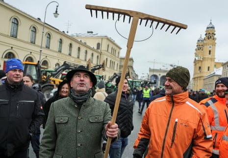 Bavarian Economic Minister Hubert Aiwanger holding a rake during today’s protests