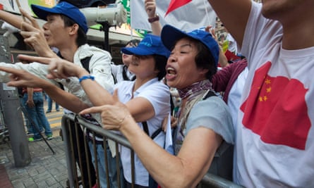 Pro-China supporters shout at pro-democracy demonstrators in Hong Kong.
