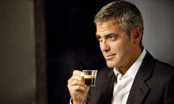 Handsome billionaire actor George Clooney poses with Nespresso coffee.
