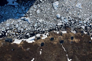 Buildings in Murray Harbour, Labrador show the scale of the ice