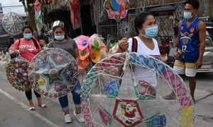 Customers walking away with newly-purchased lanterns for the festive season in San Fernando town in Pampanga province, Philippines.