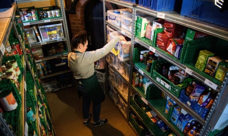 A volunteer at a Trussell Trust food bank in Wandsworth, south-west London, prepares a parcel of donated items.