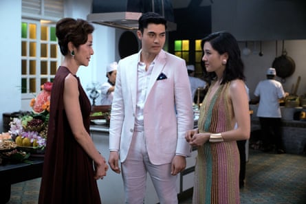 Film still showing Michelle Yeoh facing Constance Wu, while Henry Golding looks on in Crazy Rich Asians.