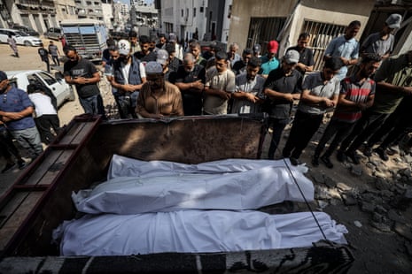 Citizens and relatives of the Palestinians killed in Israeli attacks attend the funeral ceremony after bodies were taken from the Nasser hospital for burial in Khan Younis.