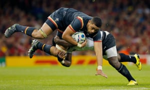 Taulupe Faletau takes a hit for Wales against Fiji in the Rugby World Cup .