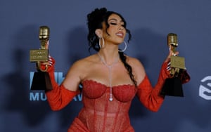 US singer Kali Uchis poses with her awards in the press room.