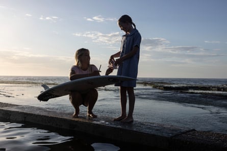Milla Brown signs an autograph for a young girl during her photoshoot