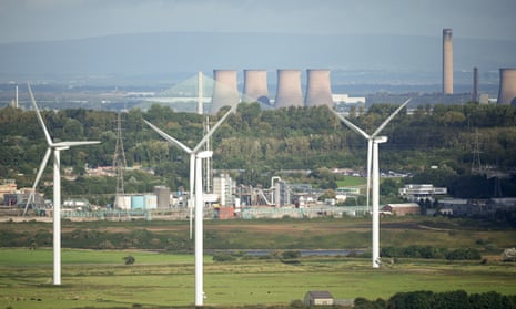 Wind turbines in front of the Fiddlers Ferry decommissioned coal fired power station in Cheshire, England