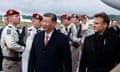 China's President Xi Jinping and French President Emmanuel Macron review the troops at Tarbes airport on Tuesday before their lunch in the Pyrénées.