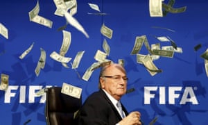 Money all round: Sepp Blater confronts the future as false dollar bills fall to the ground all around him.