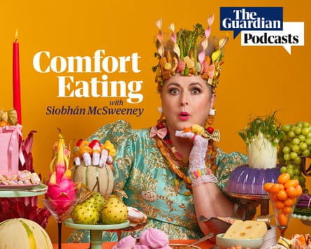 Siobhán McSweeney posing among an array of bright surreal food dishes wearing a crown made out of food