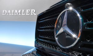 A Mercedes-Benz vehicle with the Daimler logo on a wall in the background