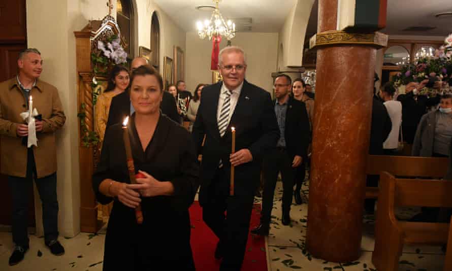 Prime Minister Scott Morrison carries a candle during Greek Easter services in Darwin. Candles, or pasha, have special symbolism during the service.