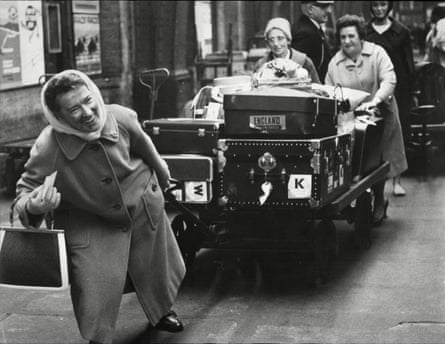 An archive photograph of women pulling along their own luggage at London’s St Pancras train station during a porter strike.