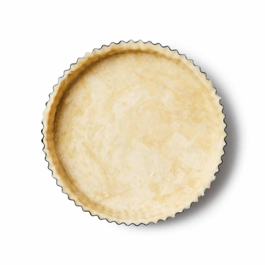 Felicity Cloake’s Bakewell tart 4a Roll out the dough on a lightly floured surface until it’s large enough to line the tin. Carefully lift it in, then top with baking paper and weigh this down with baking beans, dried pulses, rice or whatever you use in such situations, making sure they come right up the sides. Trim off any excess, then bake for about 15 minutes, until golden