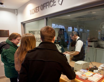 People queue at a ticket office