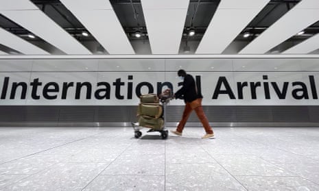 A passenger walks through the arrivals area at Terminal 5 at Heathrow airport