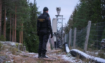 A guard walks along the boundary between Finland and Russia near the border crossing of Pelkola, in Imatra, Finland, in November.