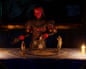 In The Killing Stone game, a horned demon looms over small figurines on a glowing ritual mat
