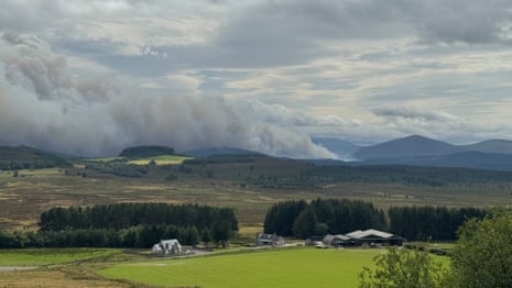 Smoke rising above a village.