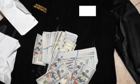 This photo, which was included in an indictment of U.S. Sen. Bob Menendez (D-N.J.), shows a jacket bearing Menendez's name, along with cash from envelops found inside the Jacket during a search by federal agents of the senator's home in Harrison, N.J., in 2022