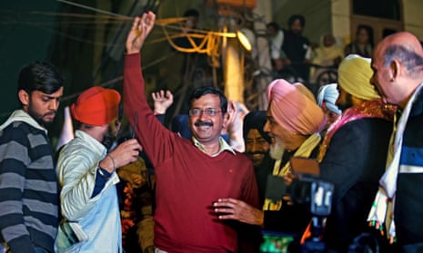 Indian Aam Aadmi party (AAP) chief Arvind Kejriwal greets supporters during an election rally in Delhi. 