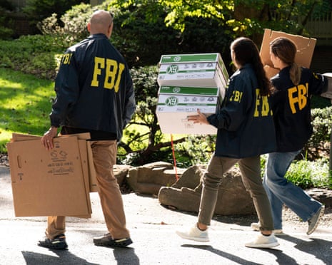 FBI agents carry empty boxes to former national security adviser John Bolton's house.