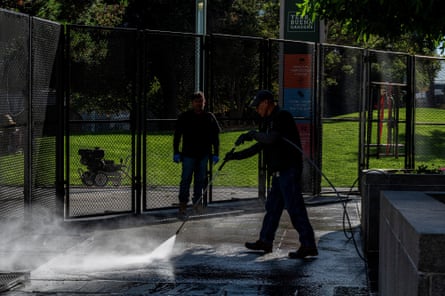 A worker cleans the pavement outside of the Moscone Center ahead of the Apec summit.